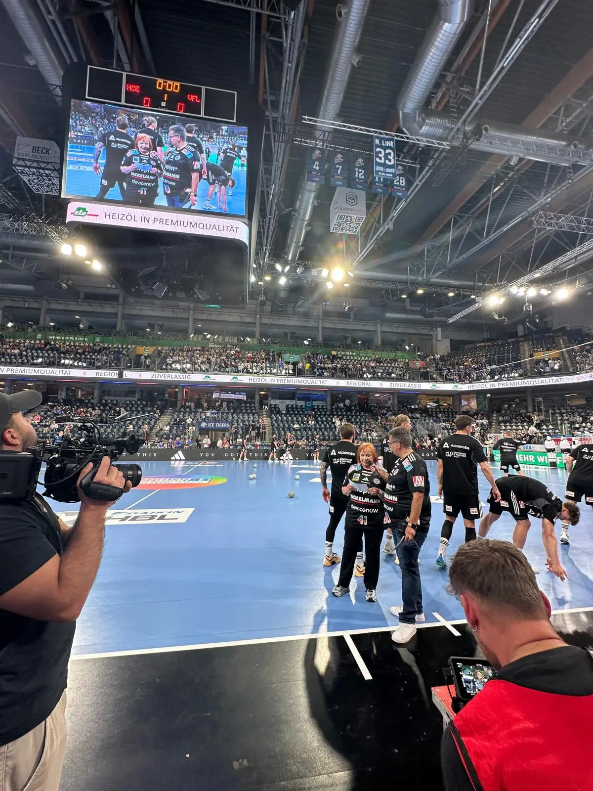 Handball-Mannschaft bei Siegerehrung auf dem Spielfeld vor vollbesetzten Tribünen – Vielfalt gewinnt Tour